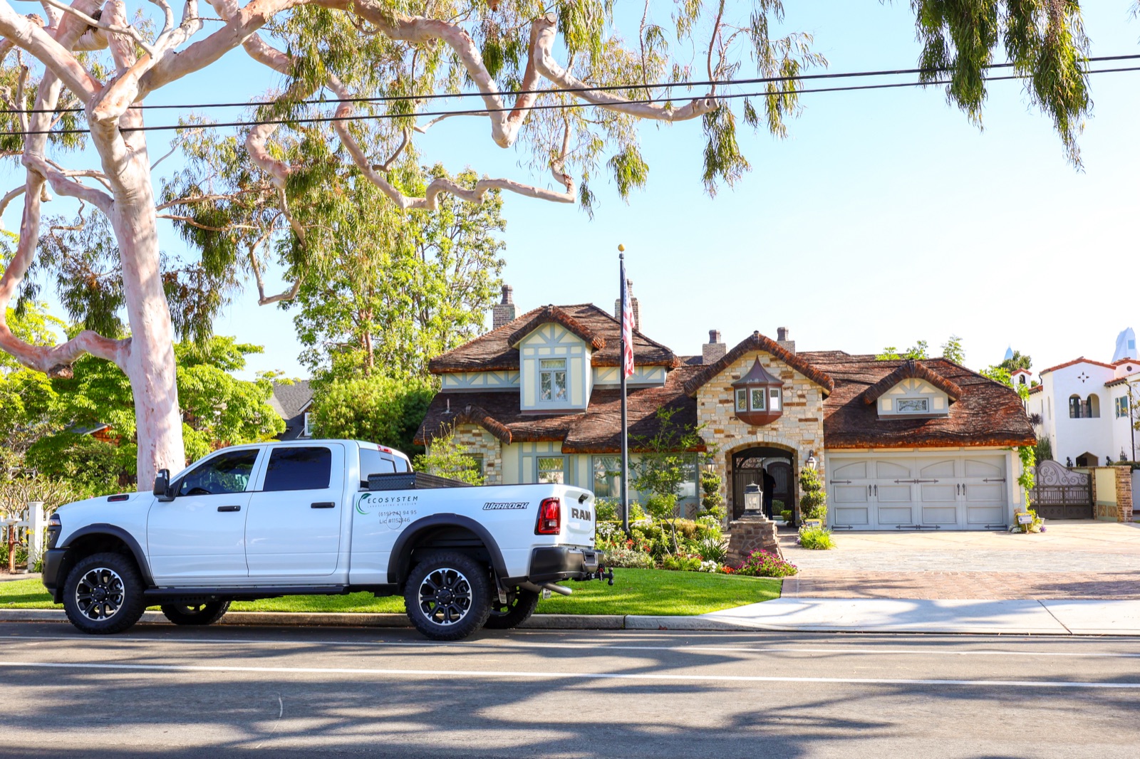 Ecosystem Landscaping branded truck parked outside a Coronado estate they service